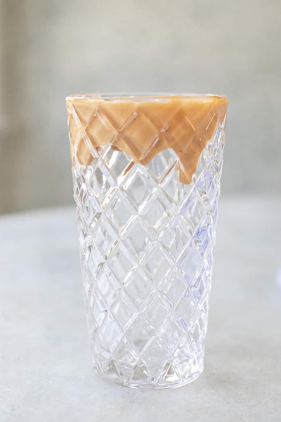 tall glass with a peanut butter rim