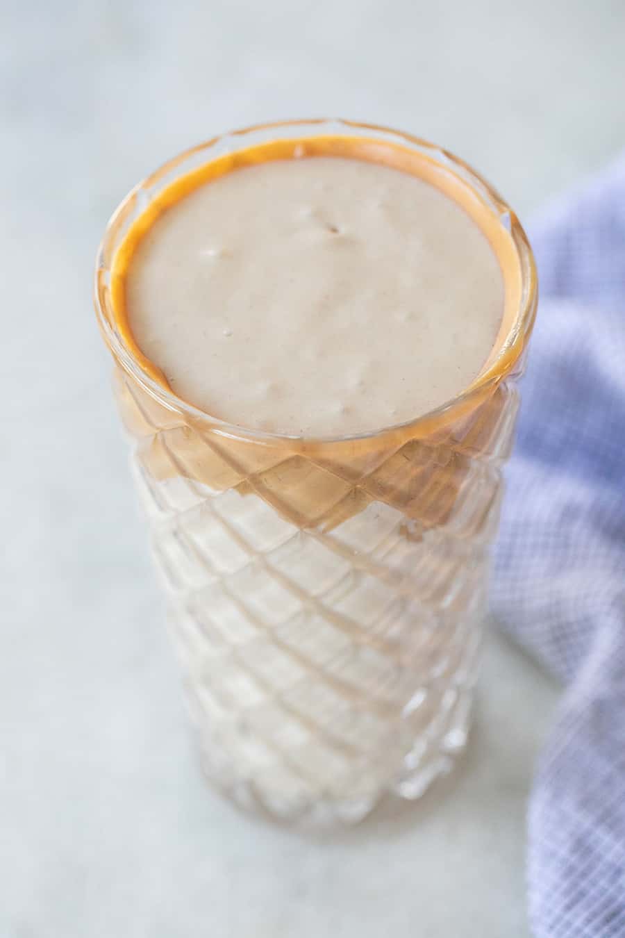 Peanut butter banana smoothie with a peanut butter rim