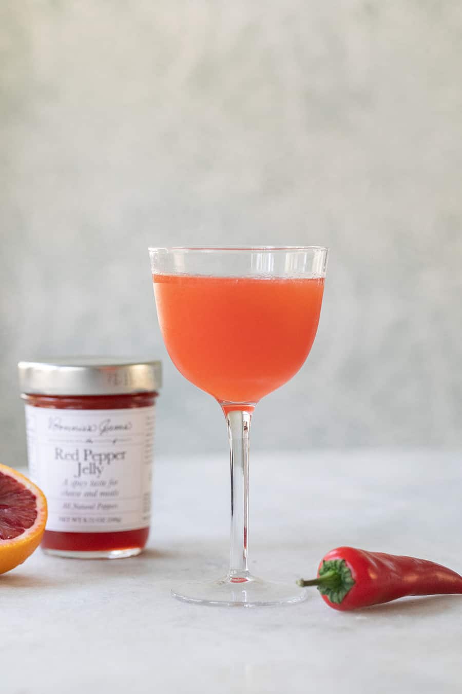 Red pepper jelly cocktail in a coupe glass