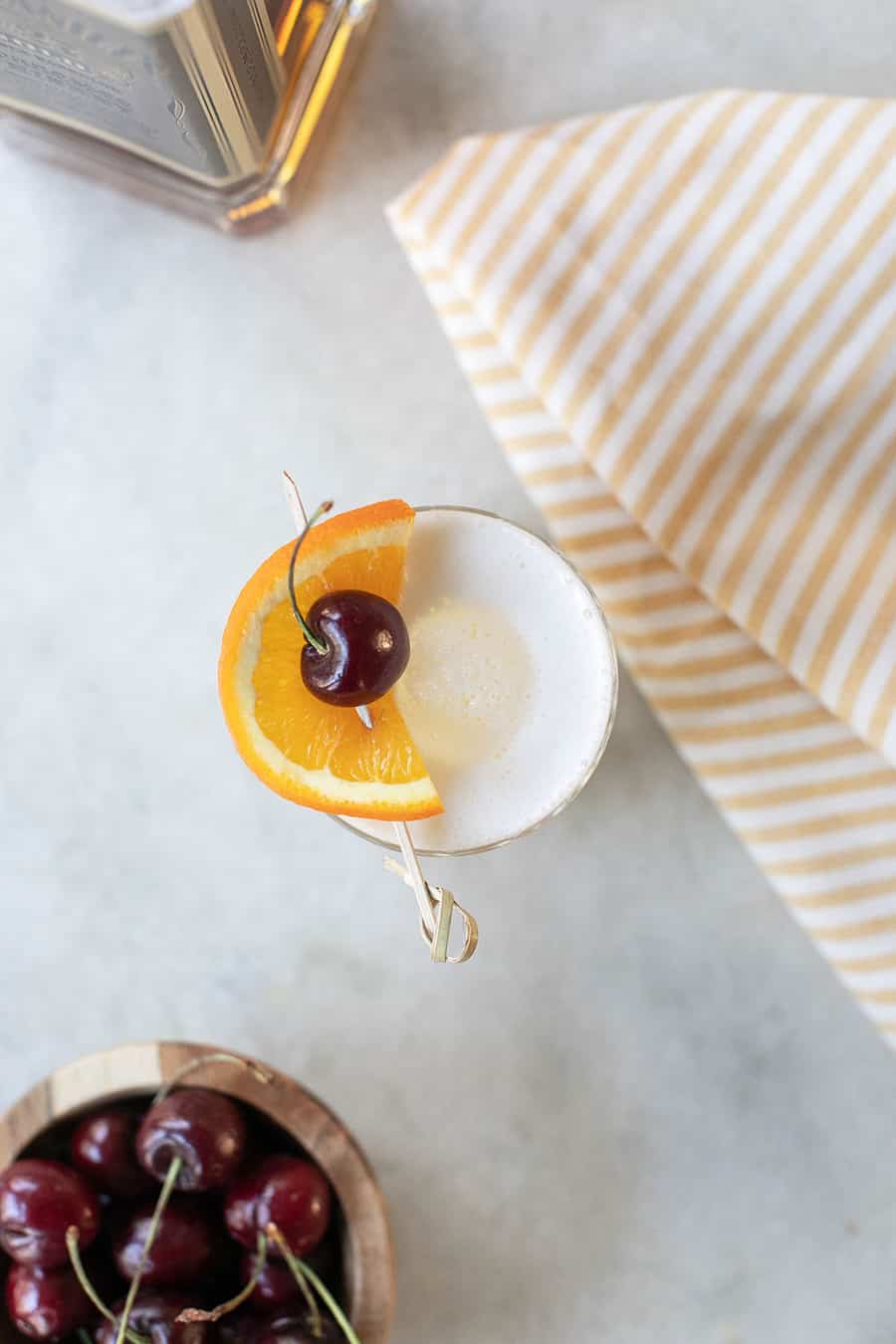 cocktail with egg white, bourbon and cherry 