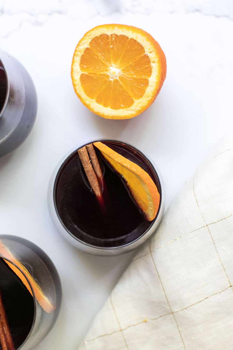 Mulled wine with an orange slice and cinnamon stick