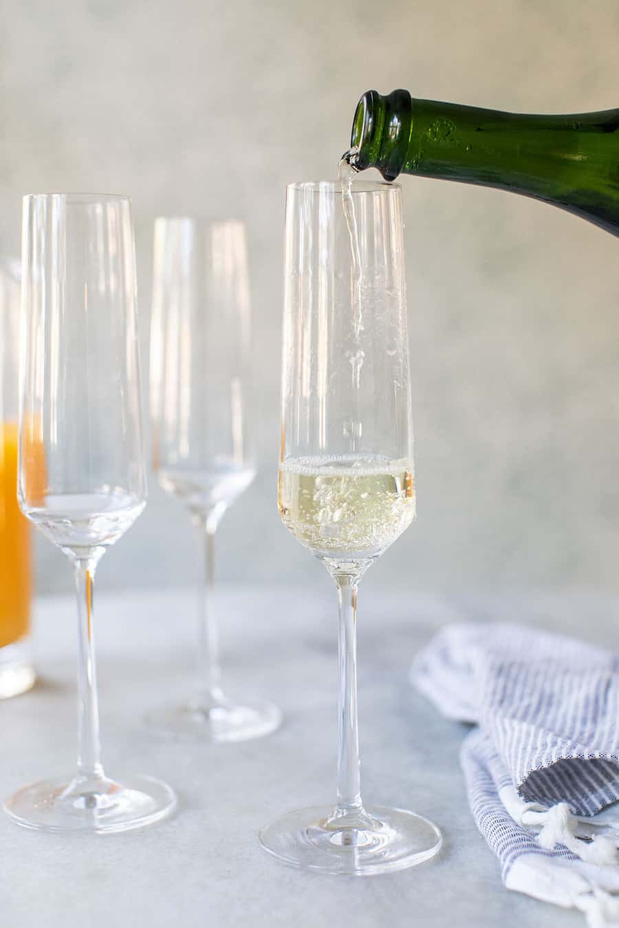 Sparkling white wine being poured into a Champagne Flute. 