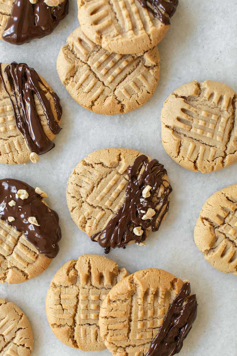 Cookies drizzled with chocolate and crushed peanuts.