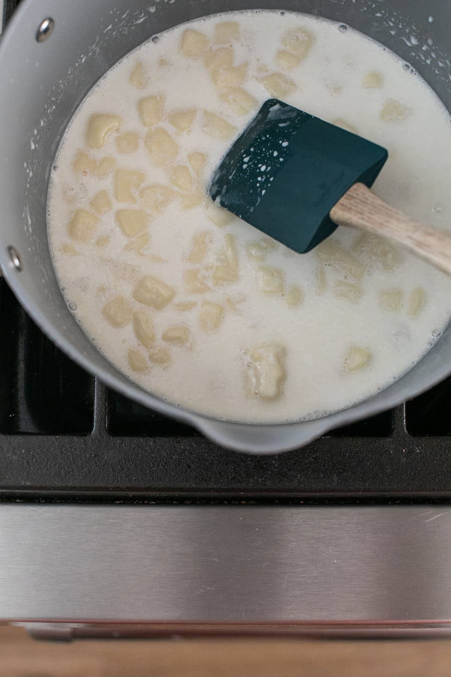 Melting American white cheese and milk together in a nonstick pan