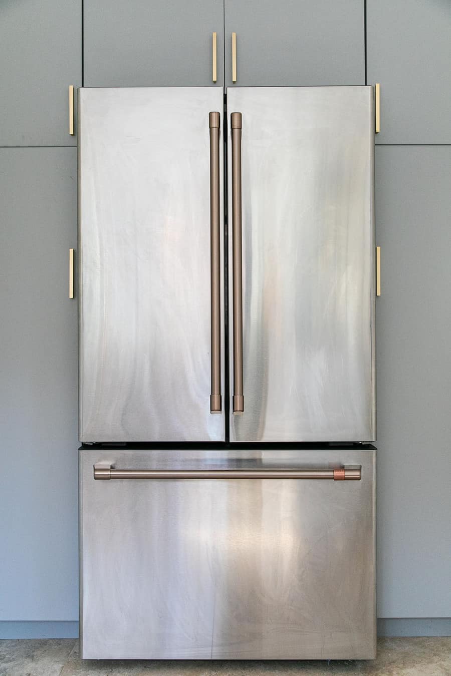 Cafe Appliances stainless steel refrigerator with brushed brass handles