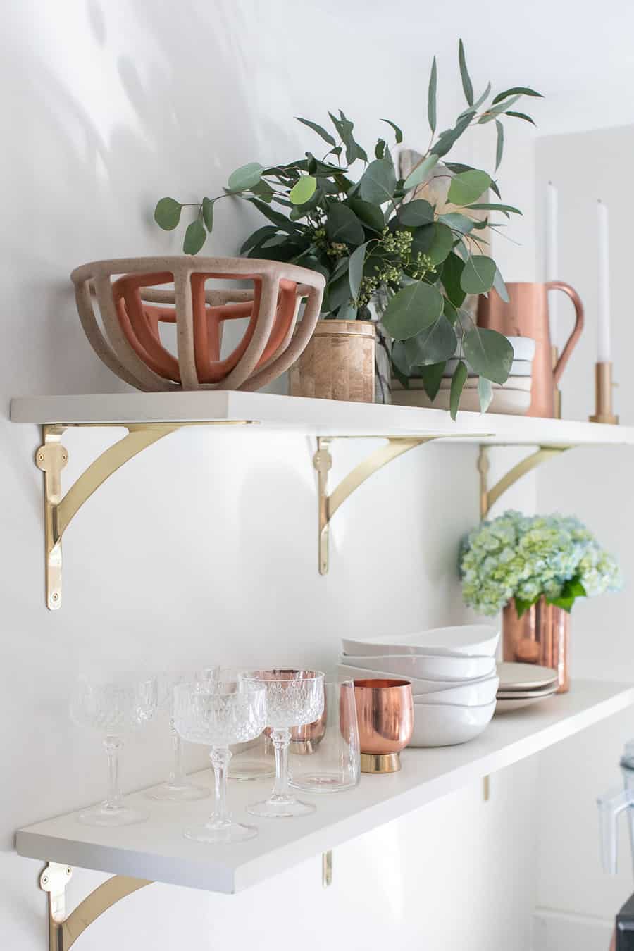 white open shelving with bowls, flowers, glasses and plates