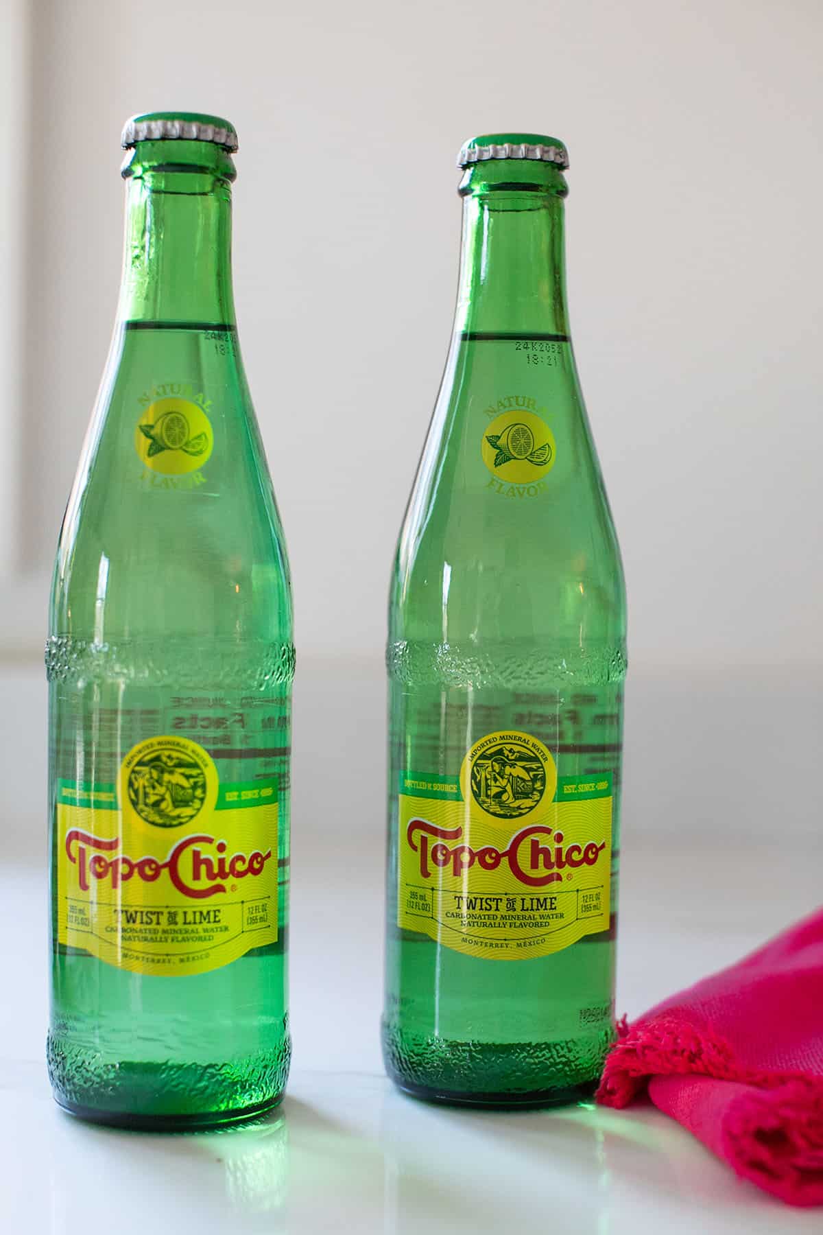Bottles of Topo Chico with a twist of lime.