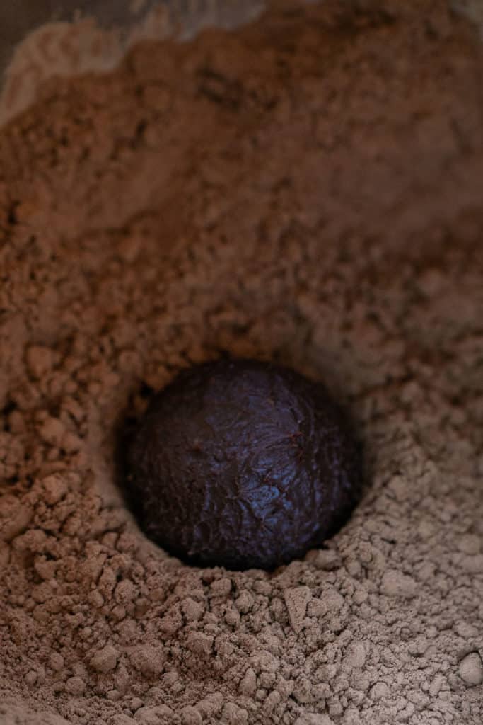 rolling chocolate truffle in cocoa powder 