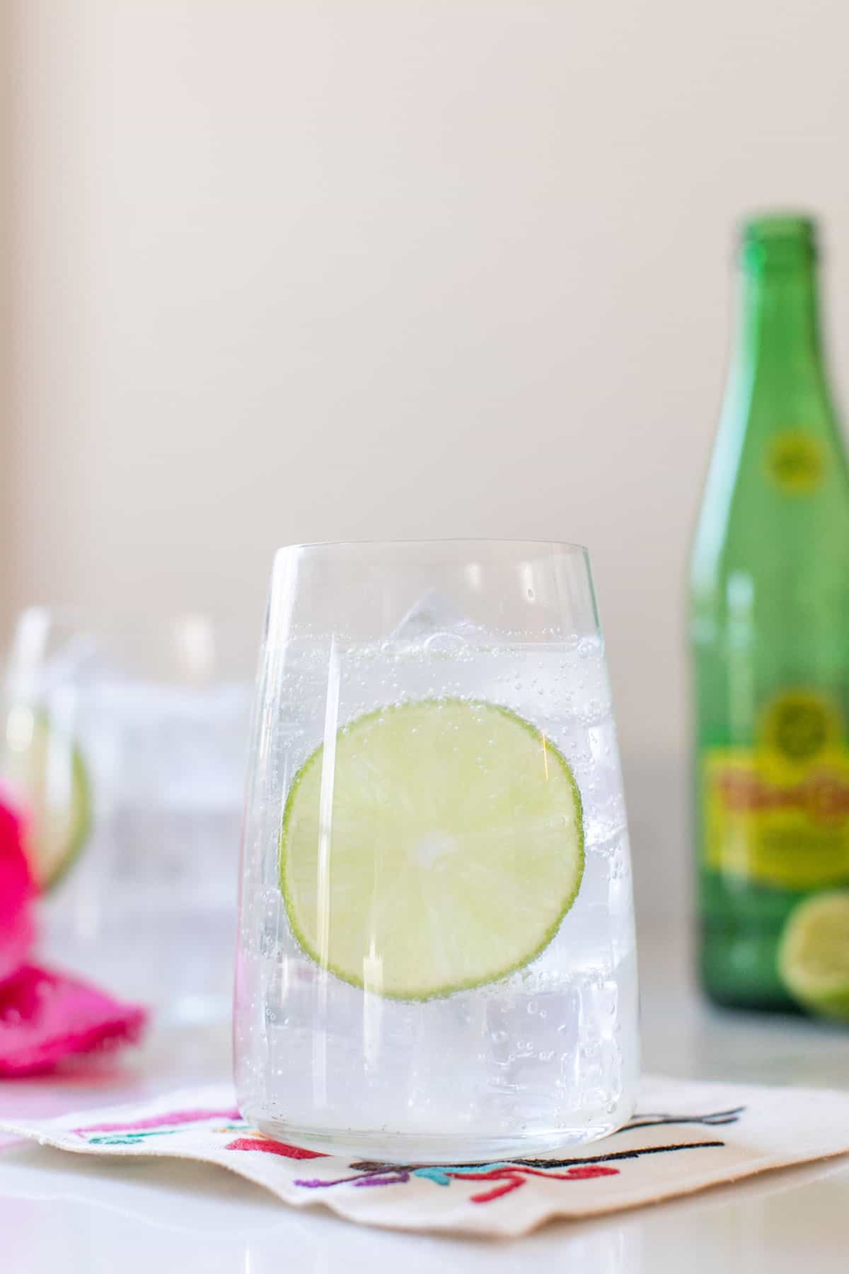 Ranch water cocktail in a glass with a slice of lime. 