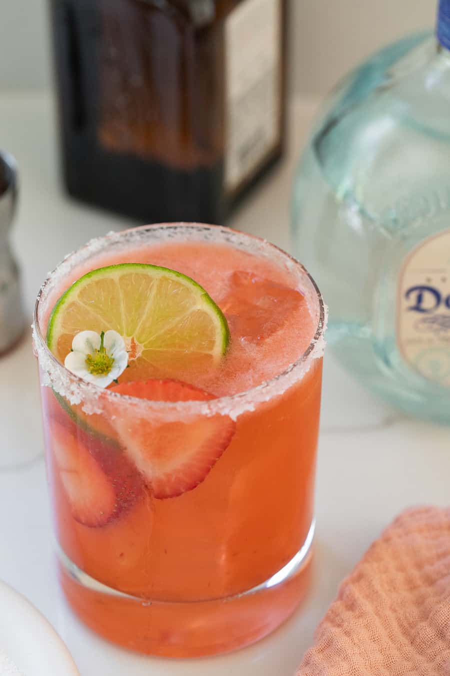 Strawberry margarita recipe with lime, flowers and strawberries. 