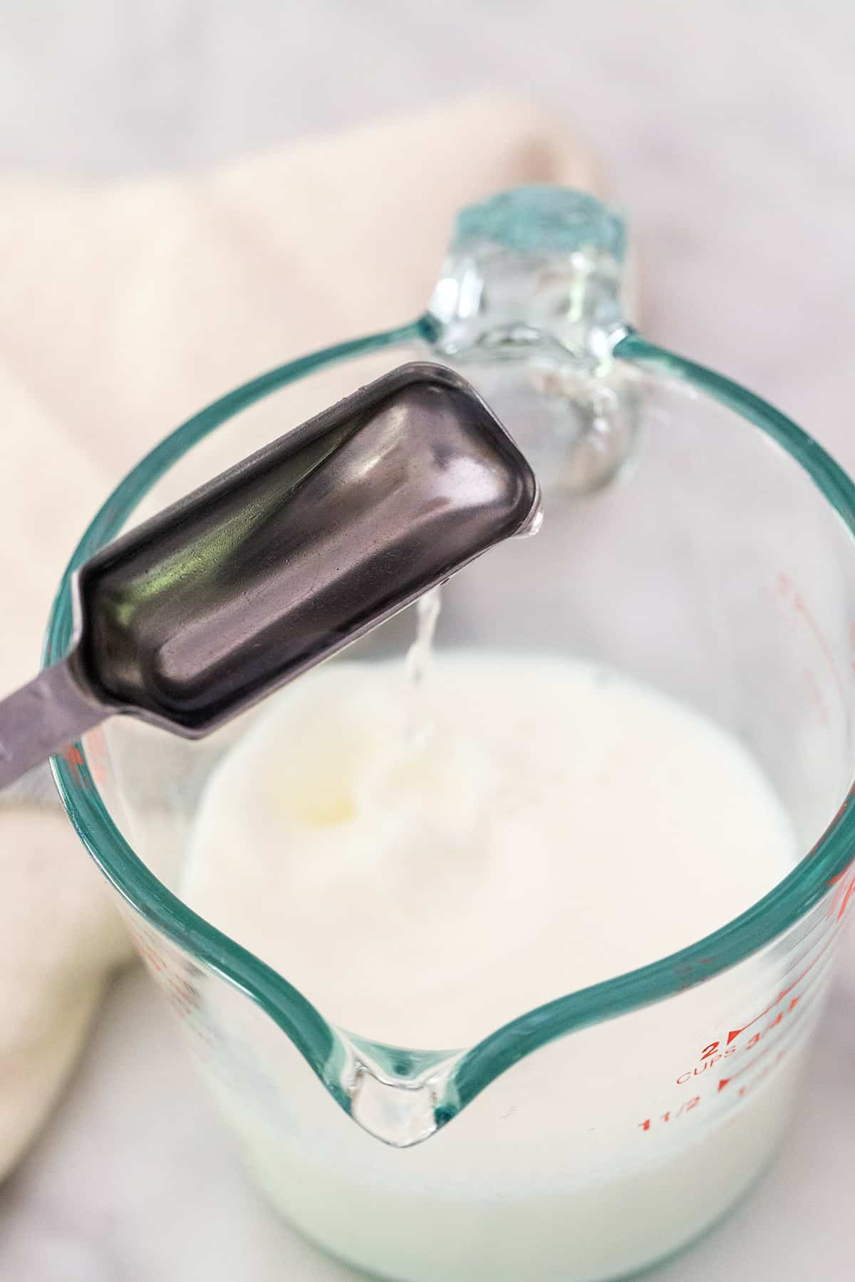 Adding a tablespoon of vinegar to milk to make buttermilk