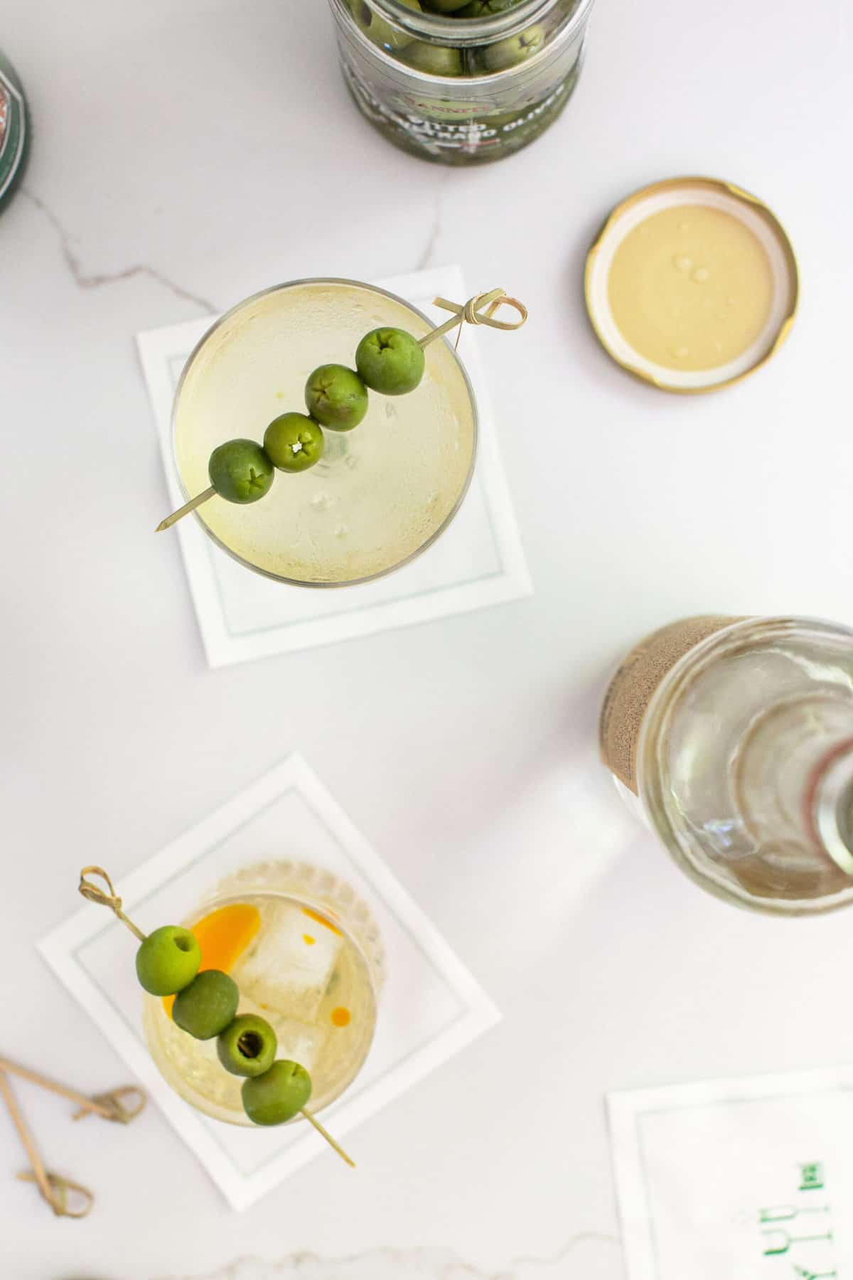 A classic dirty martini and a dirty martini made with tequila 