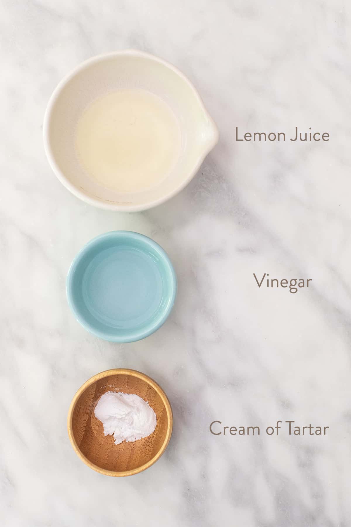 Lemon juice, vinegar and cream of tartar in small bowls.