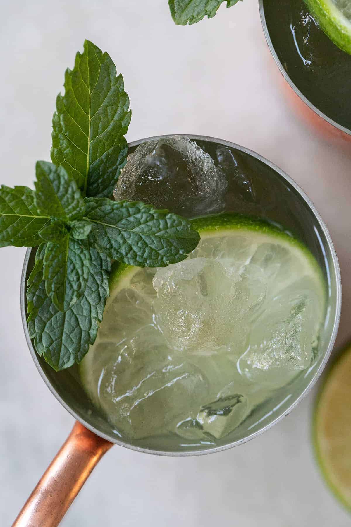 gin mule recipe in a copper mug with mint and lime