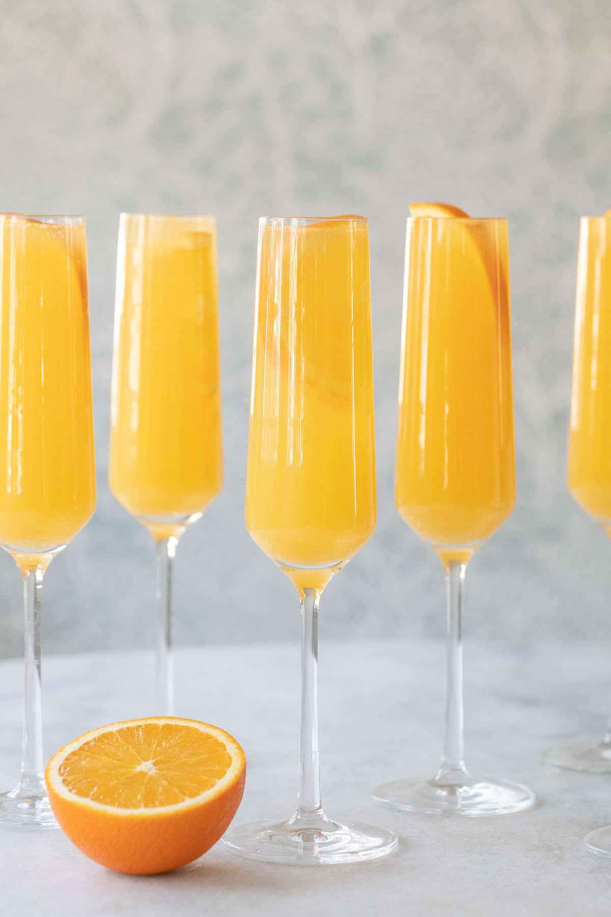 Mimosas on a table are cheap alcoholic drinks to make 