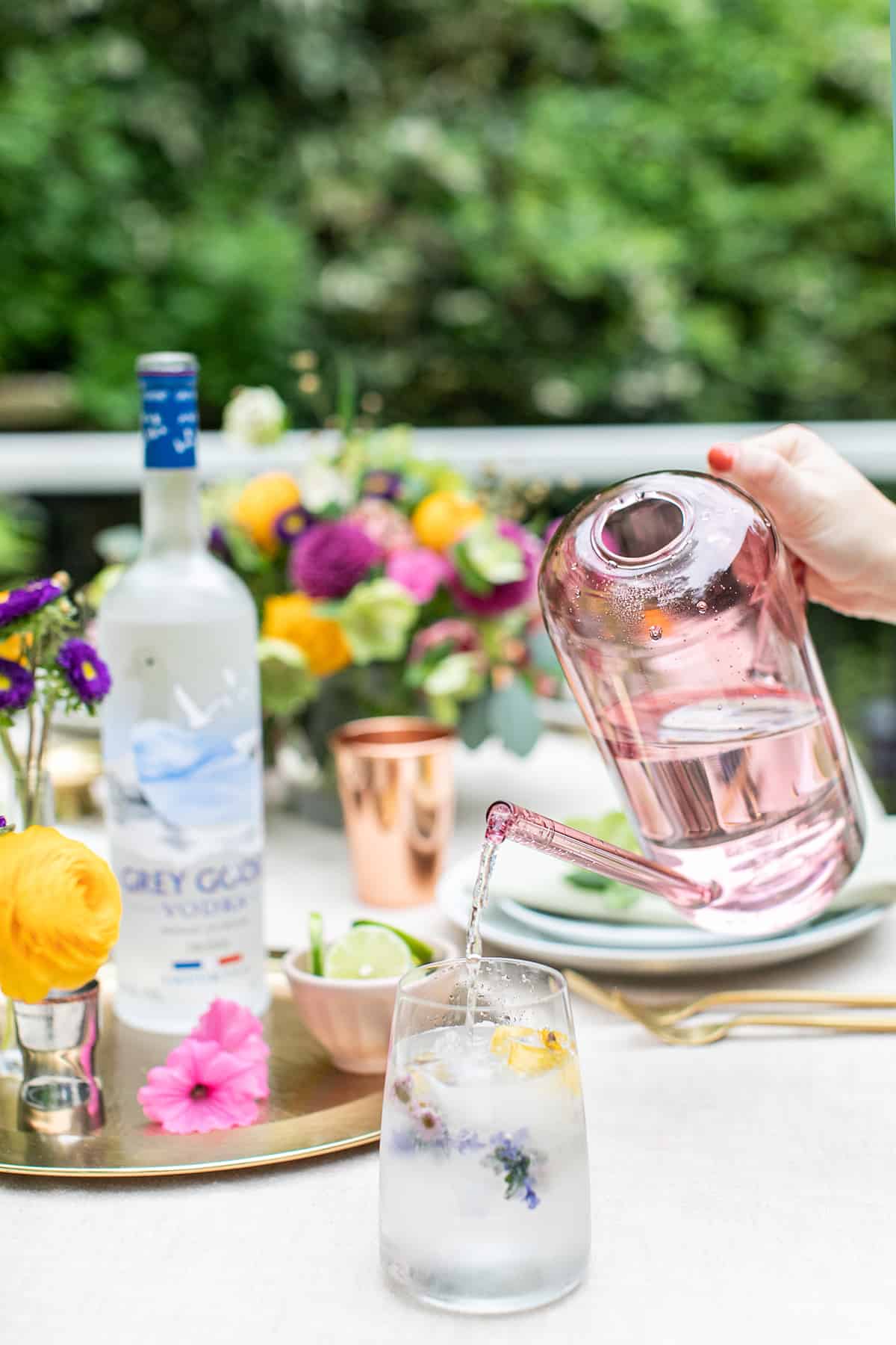 Pouring club soda into a cocktail recipe.