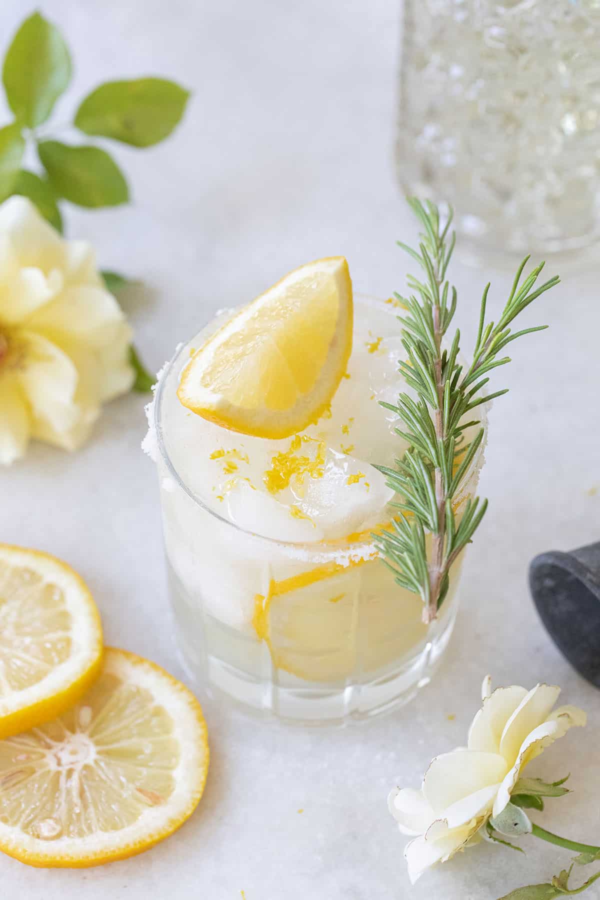 A lemon margarita with a lemon wedge on the top.