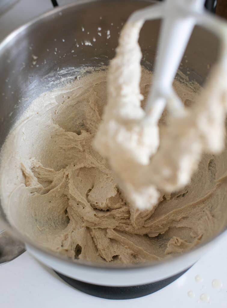 Mixing apple cider donut batter in an electric mixer.