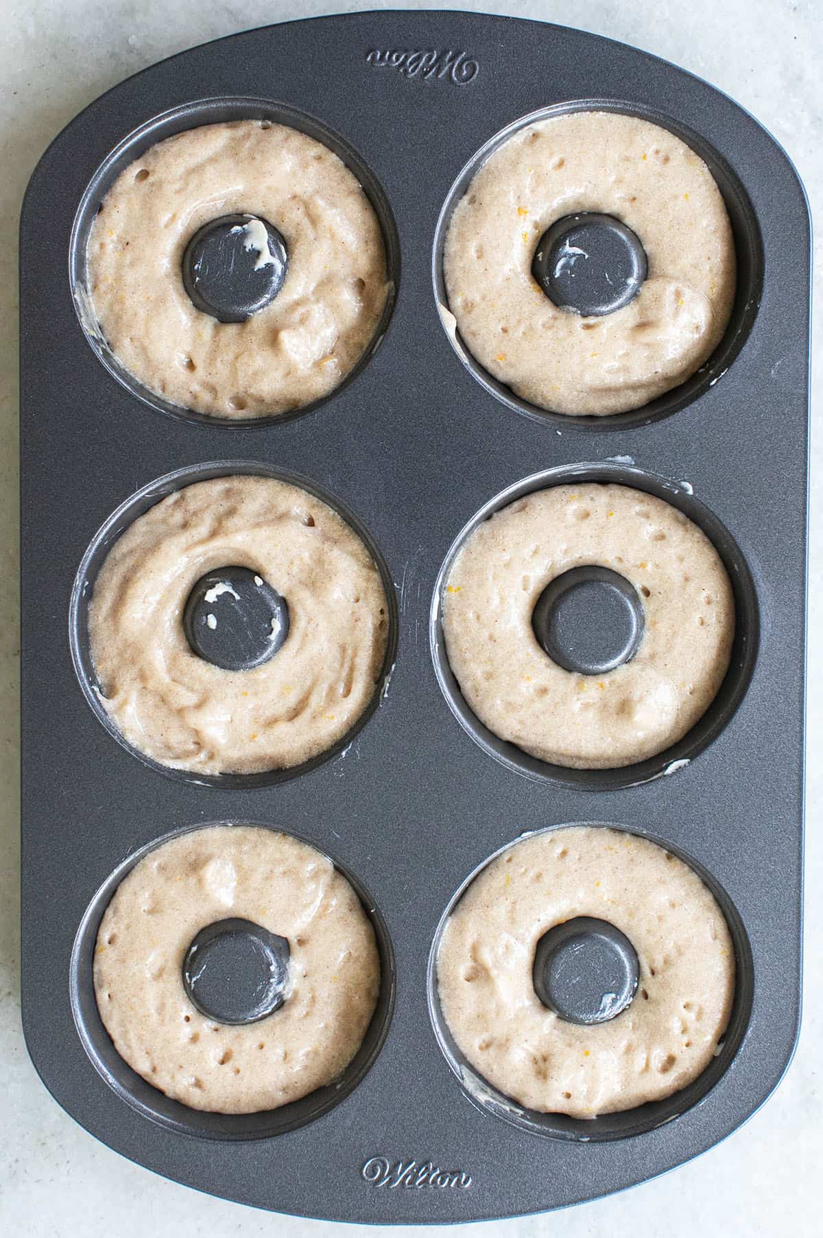 Donut batter in a donut pan.