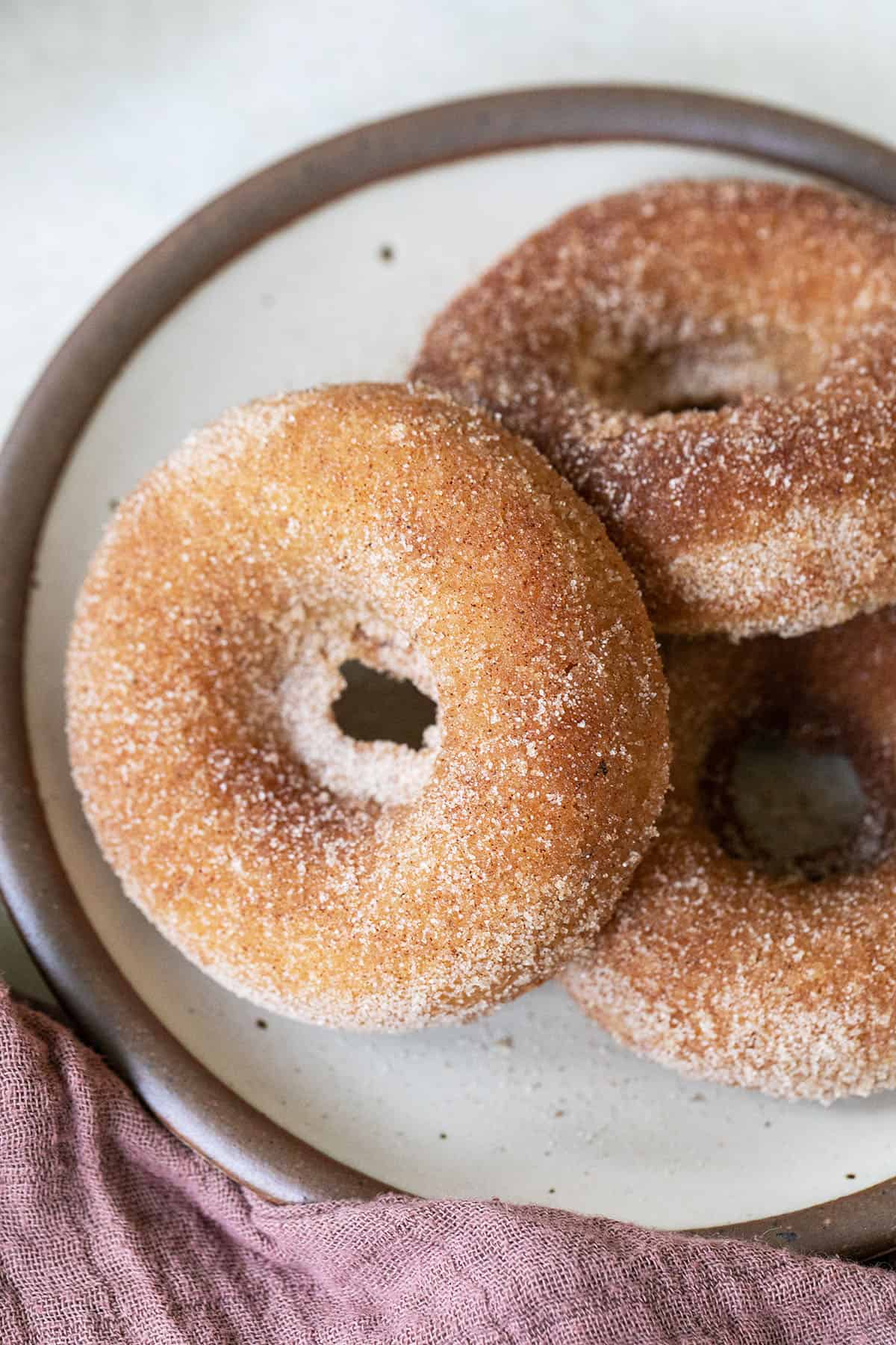 baked apple cider donuts with sugar.