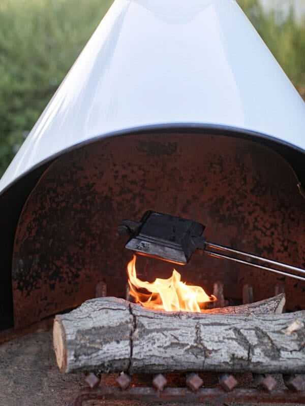 Campfire pie cooking over a fire.