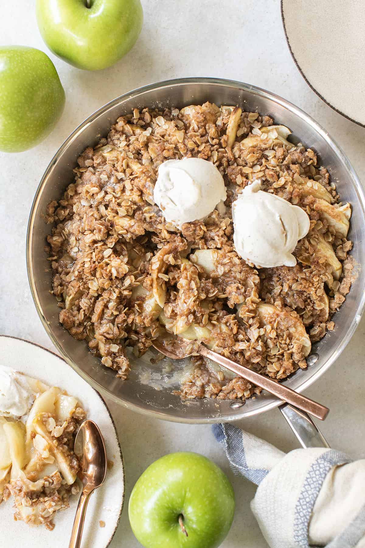 Apple crisp recipe is a copper pan with ice cream.