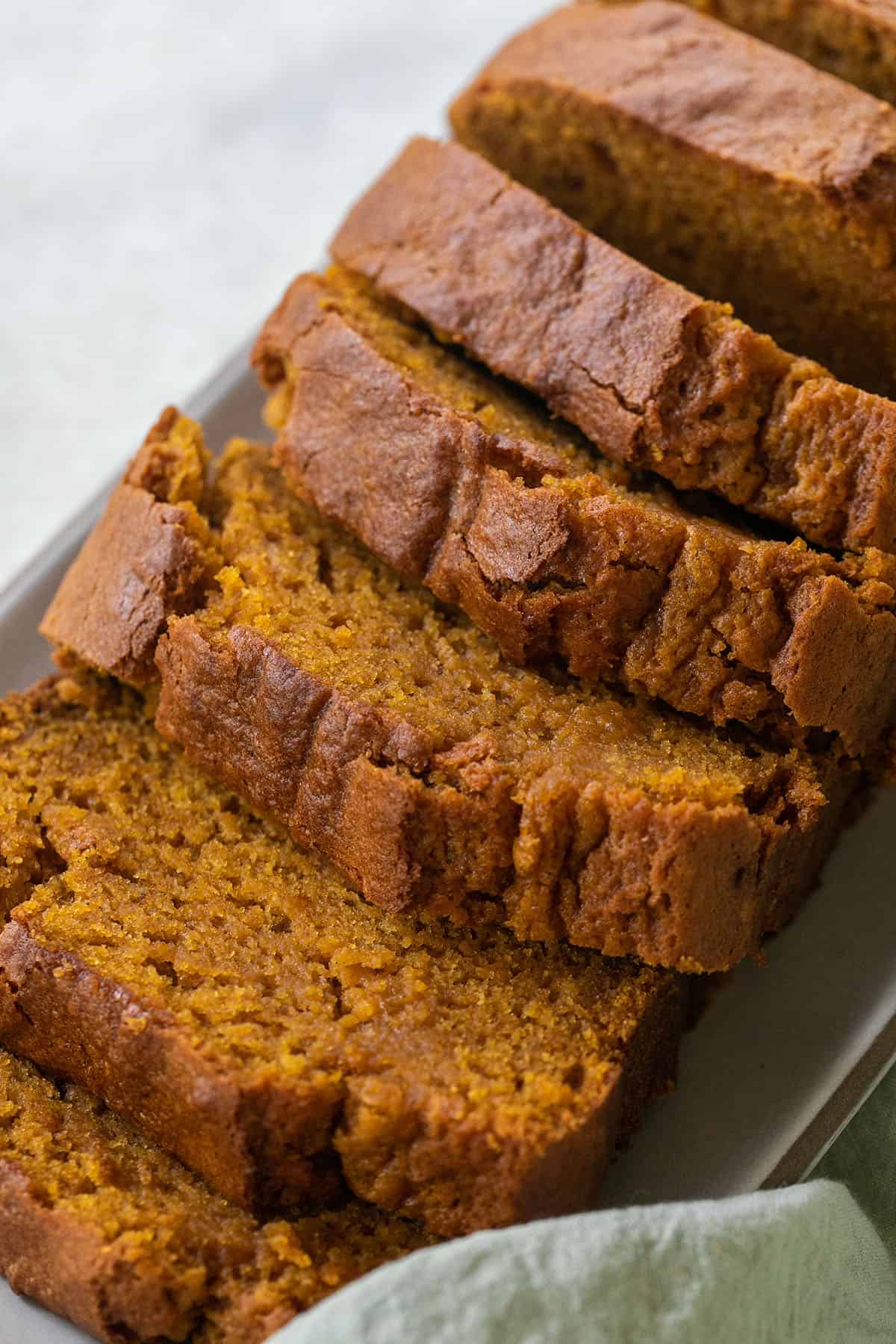 Moist homemade pumpkin bread cut into thick slices.