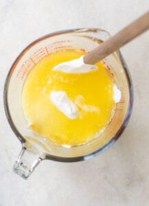 sour cream, melted butter, eggs and vanilla extract in a measuring cup