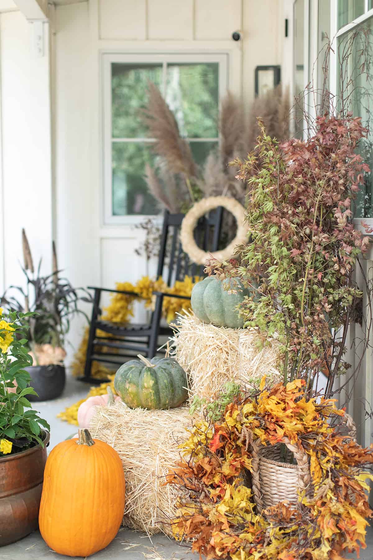 Fall porch ideas with pumpkins, wreaths and fall decor.