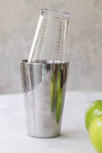 cocktail shaker filled with an apple martini