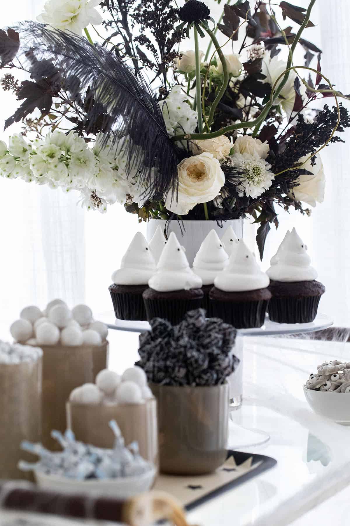 Halloween candy and cupcakes on a bar.