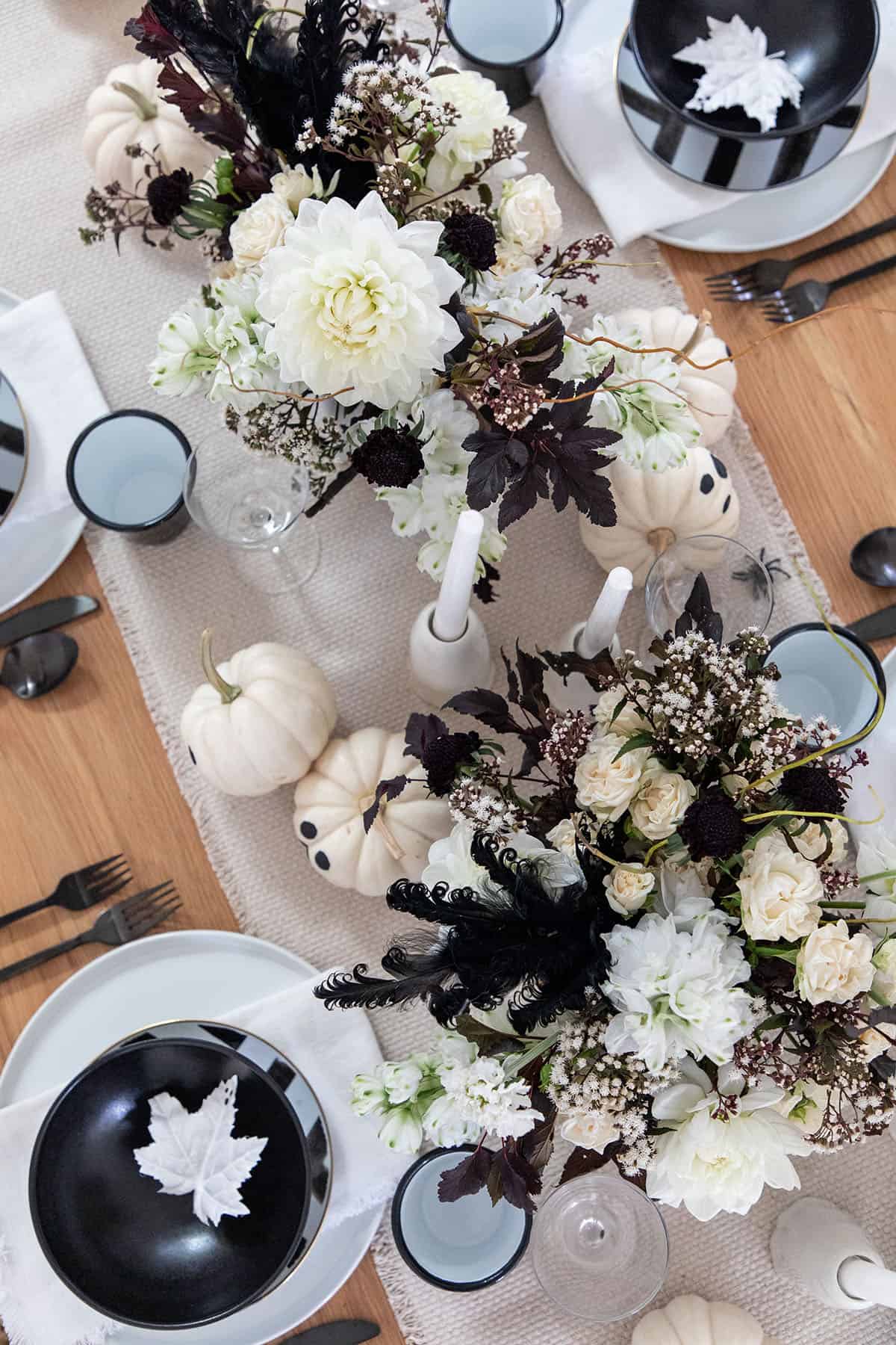 halloween party with blackened white flowers and ghost decorations