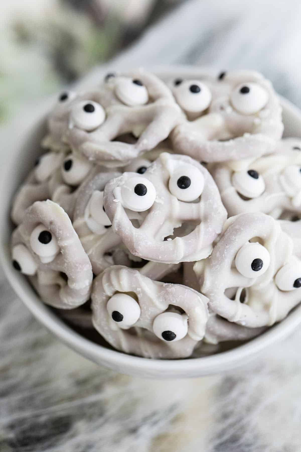 Mini yogurt pretzels with eyes.