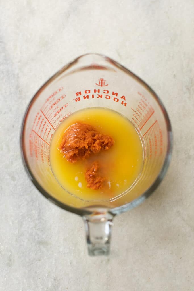 Butter, pumpkin puree and egg in a liquid measuring cup.