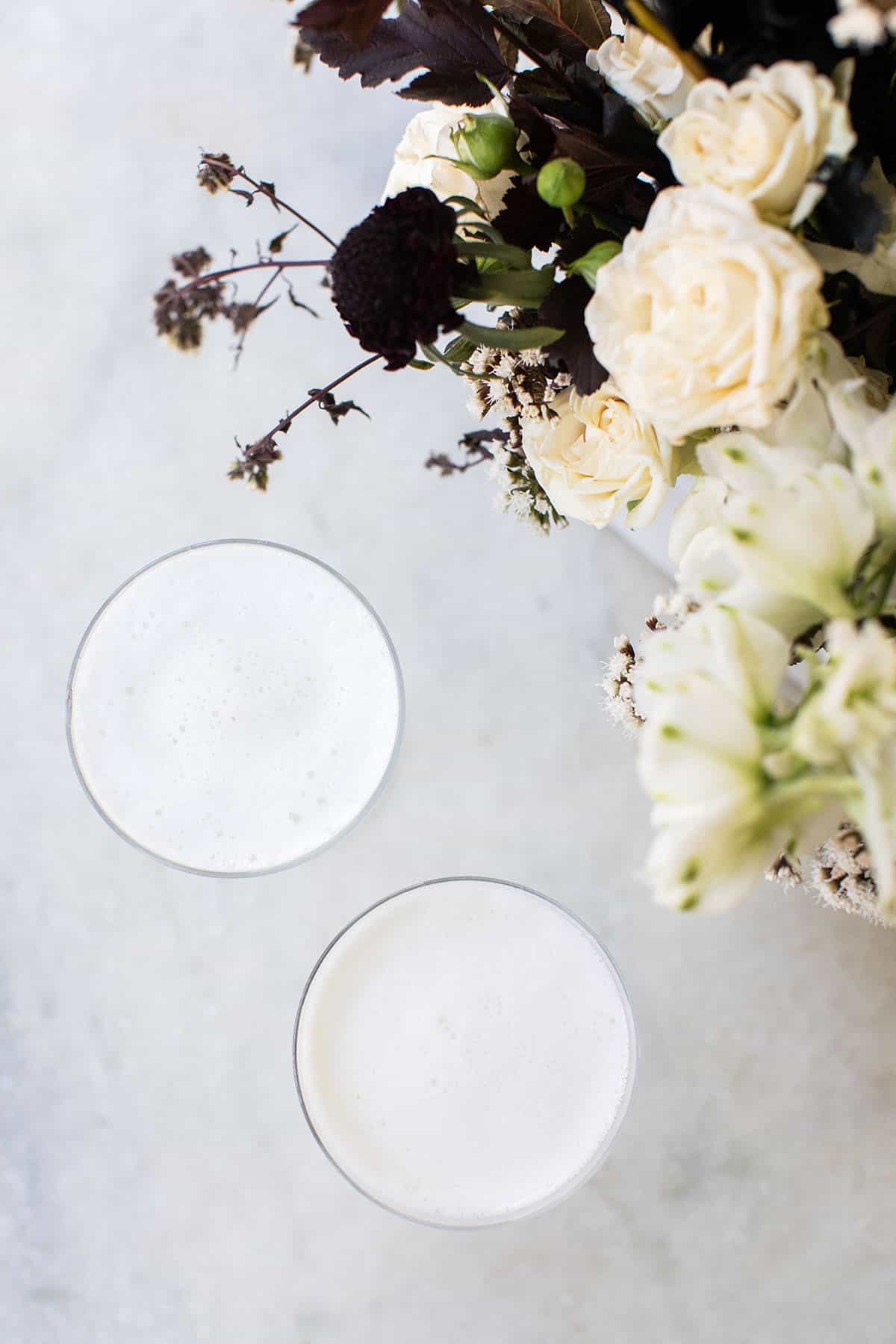 two white cocktails with foam