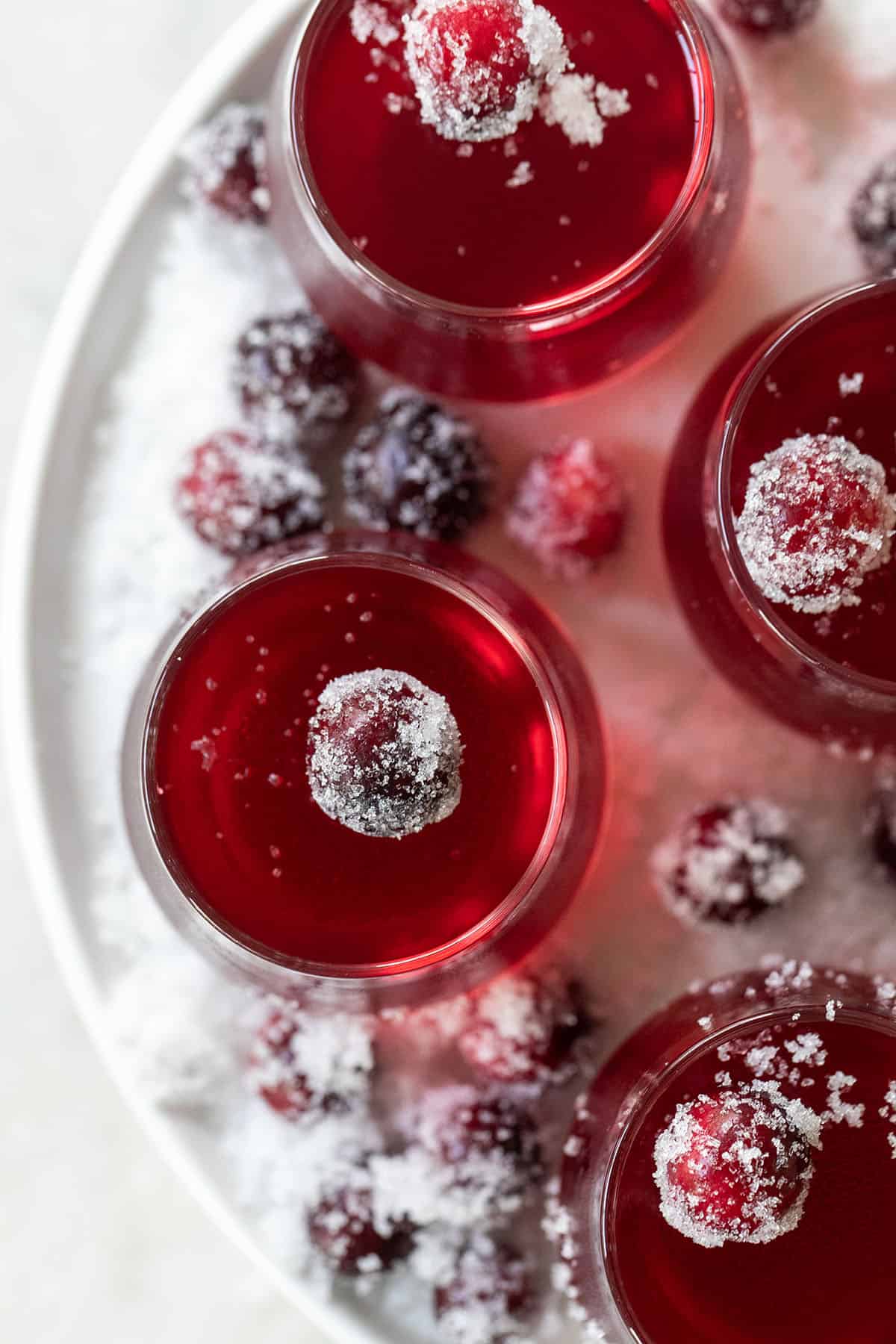 Jello shots for the holidays with cranberry - jello shot cups, sugared cranberries, shot glasses