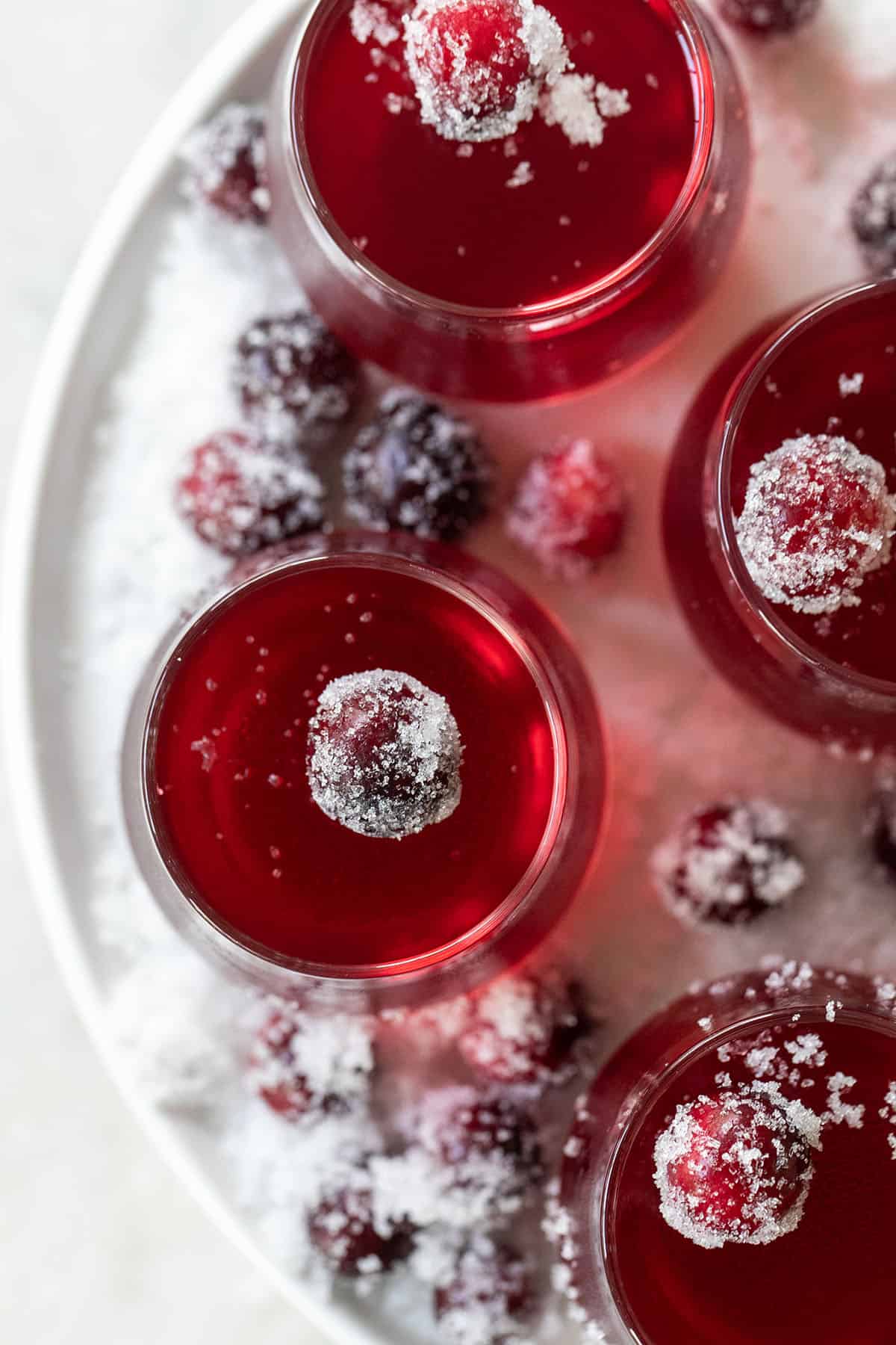 Red cranberry Jello shot with sugared berries.