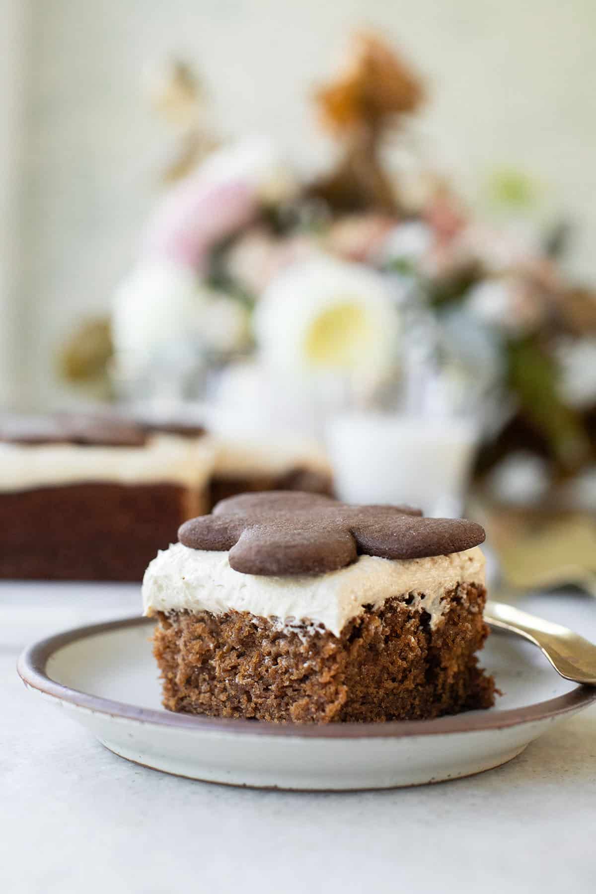 Easy gingerbread cake sliced with a gingerbread cookie. 