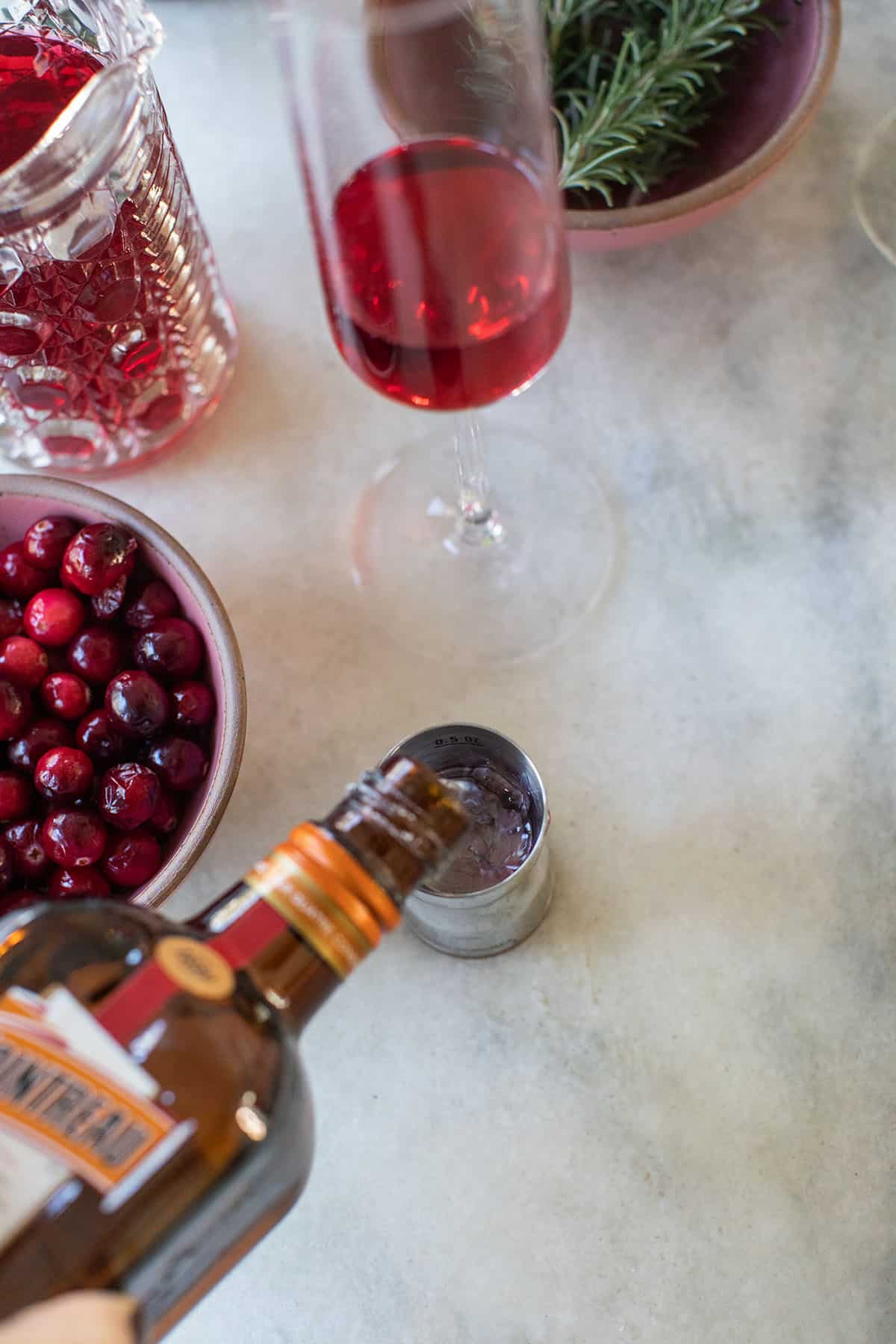 pouring orange  liqueur into a cocktail jigger - cranberry juice cocktail, fruit juice, cocktail shakers, grand marnier