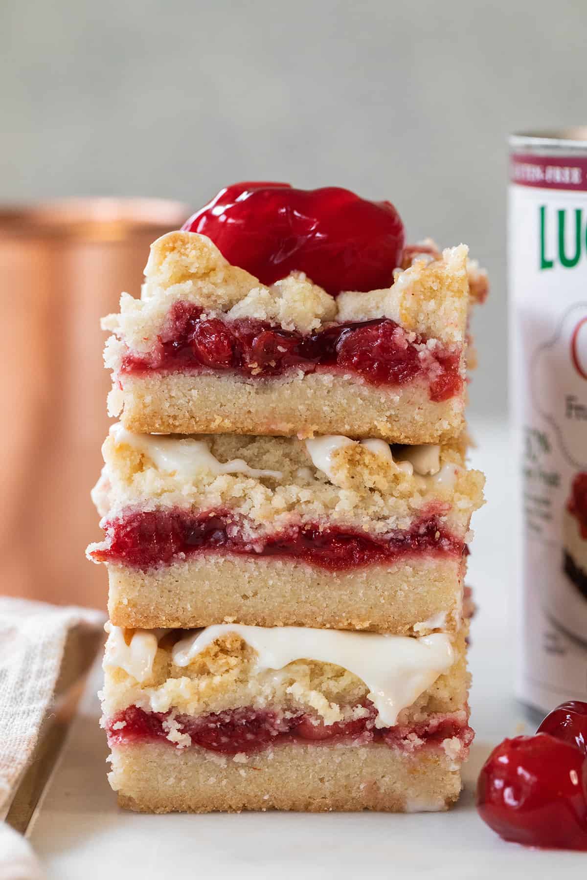 Cherry pie bars stacked with glaze.