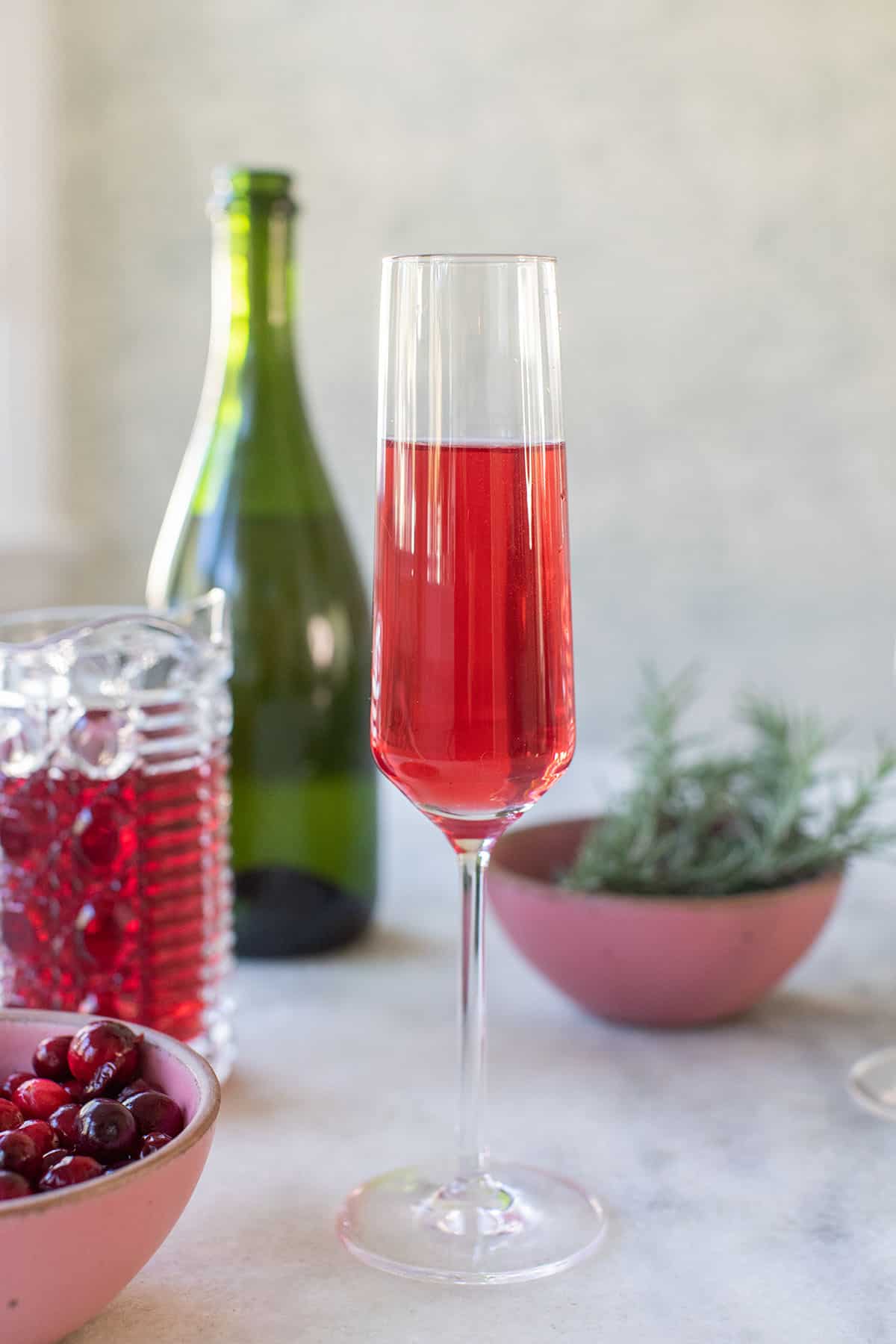 poinsettia cocktail in a Champagne flute - leftover cranberry juice, non alcoholic sparkling wine, orange twist, champagne flutes