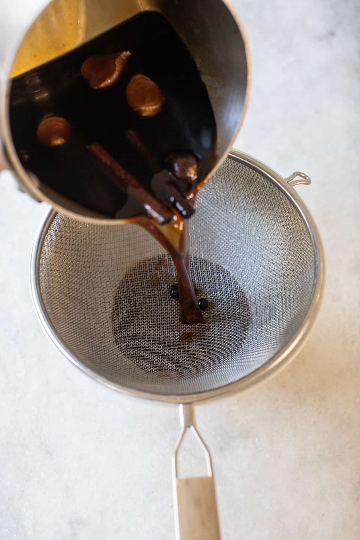 straining gingerbread syrup