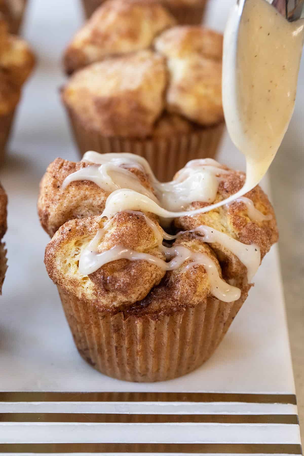 brown butter glaze drizzled over monkey bread muffins