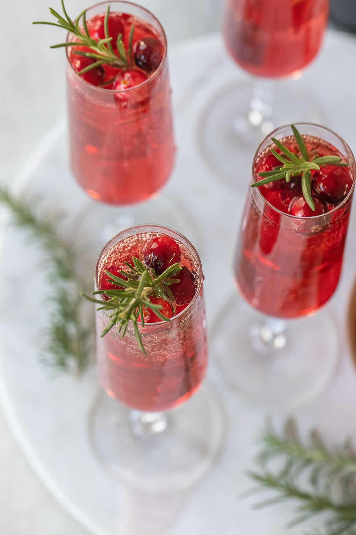 Champagne cranberry cocktail - a few fresh cranberries, 100 cranberry juice, plain champagne, cranberry mimosa