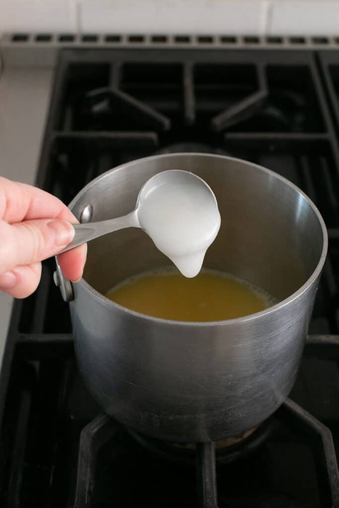 pineapple juice and coconut cream in a saucepan