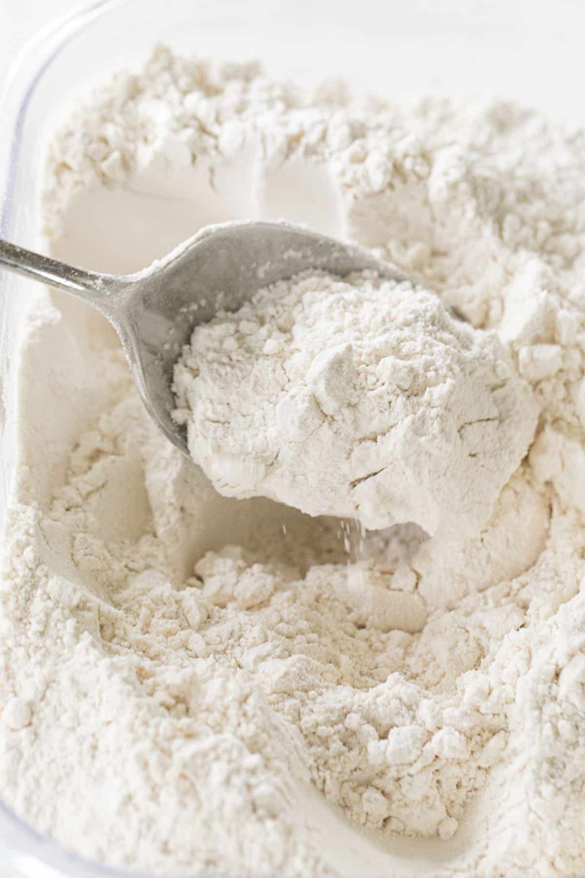fluffing flour with a spoon
