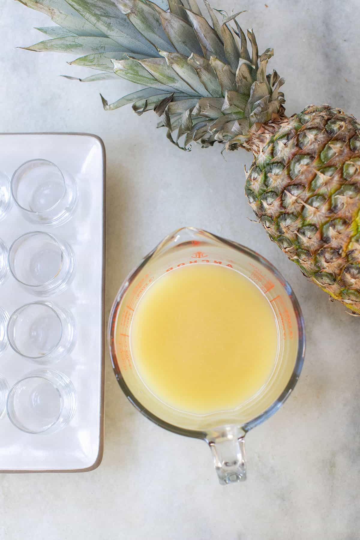 pineapple jello shot in a measuring cup