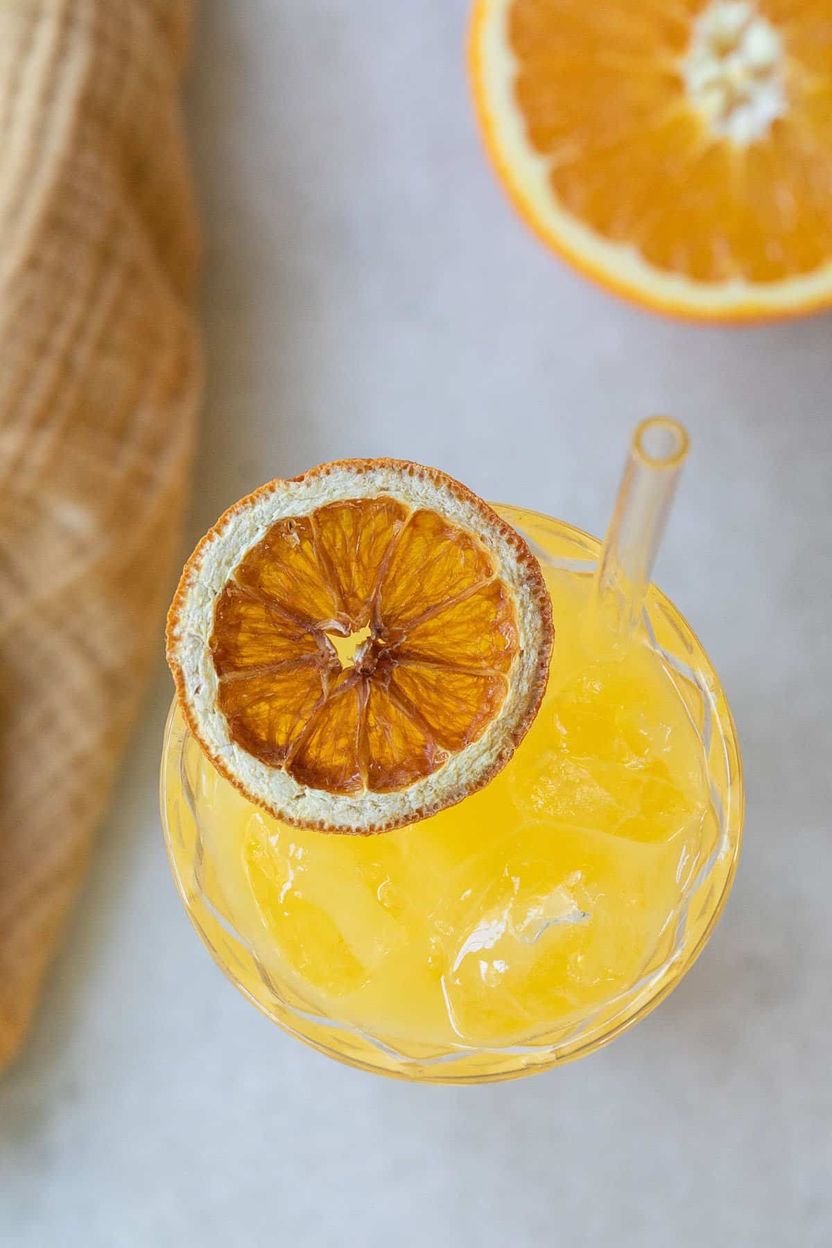 Screwdriver cocktail with a dried orange slice.