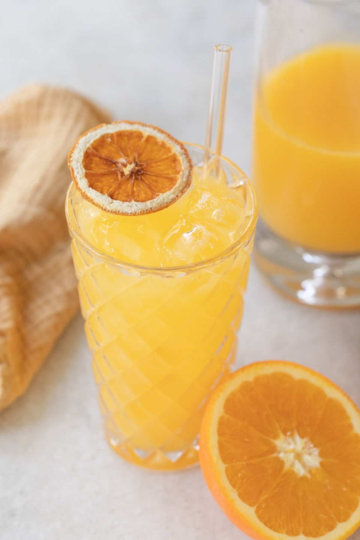 Screwdriver cocktail with a dried orange slice.