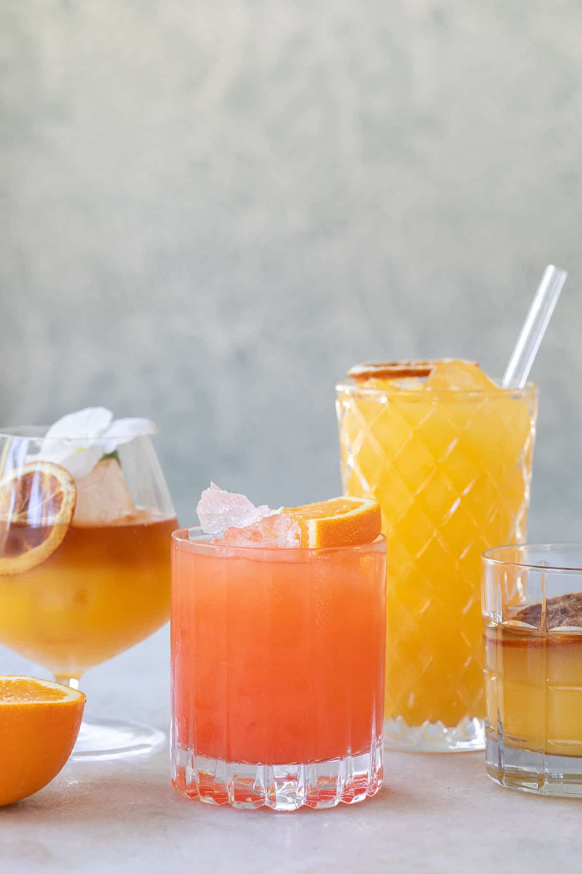 Orange juice cocktails in glasses on a white countertop. 